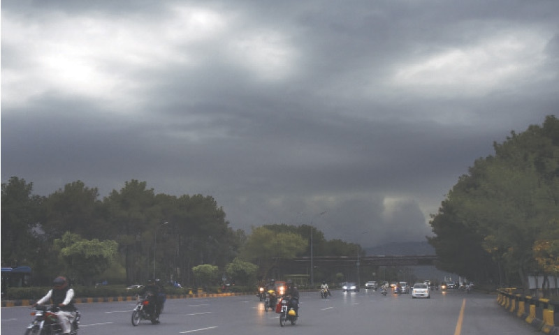 Dark clouds are seen from Faisal Avenue in Islamabad on Saturday. The twin cities have been receiving intermittent rains for the last few days. The current spell is expected to continue till Sunday. &mdash; Photo by Tanveer Shahzad