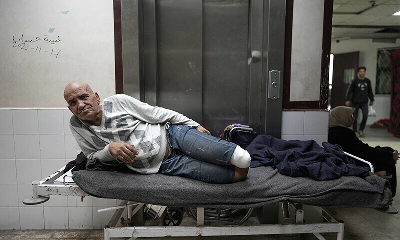 An amputated Palestinian man lies on a bed in the corridor at the Shuhada Al Aqsa Hospital in Deir el-Balah in the central Gaza Strip on April 3. &mdash; AFP