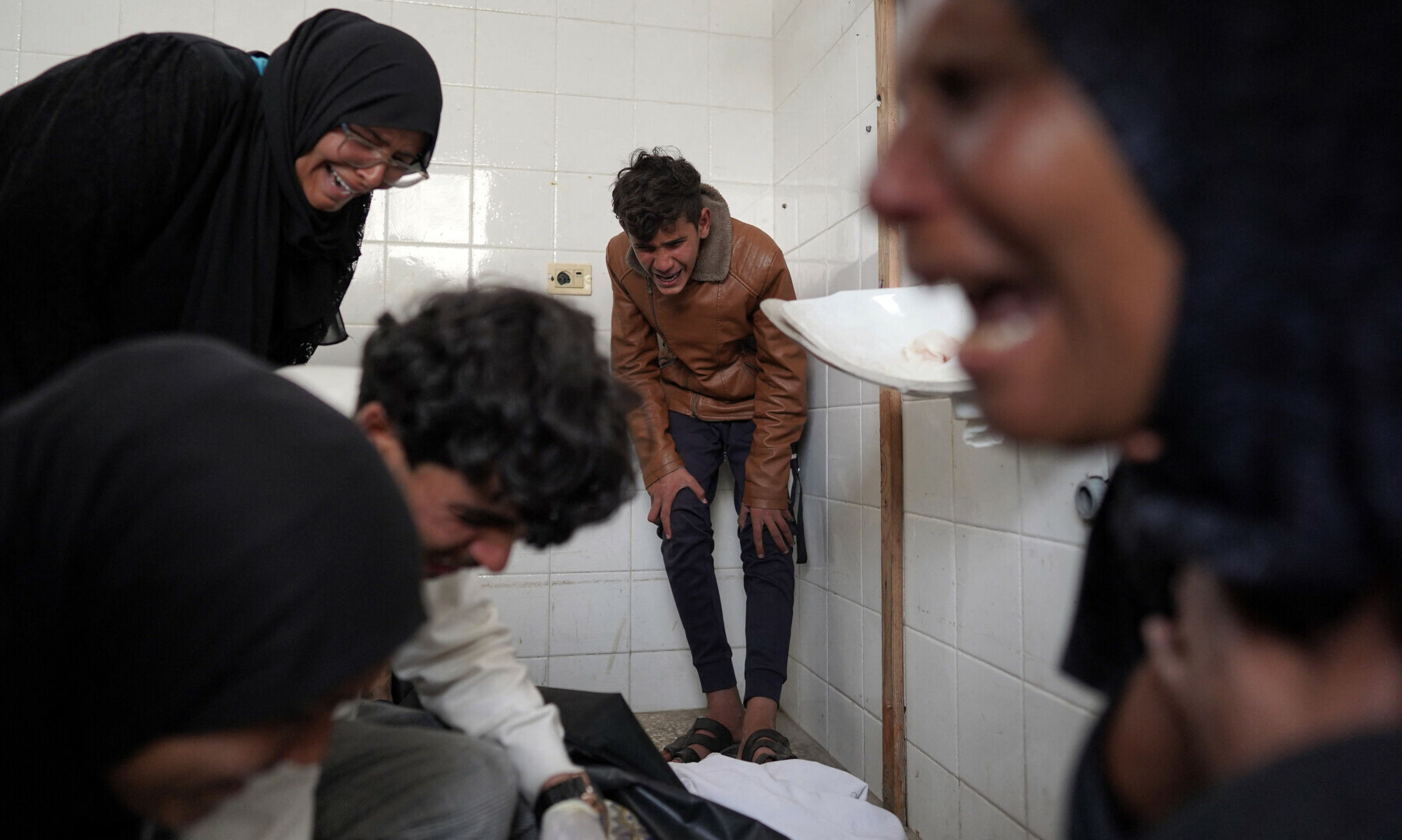  Relatives mourn over the dead body of a Palestinian man, at the Al-Aqsa Martyrs Hospital in Deir al-Balah, central Gaza Strip on March 28. &mdash; AFP 