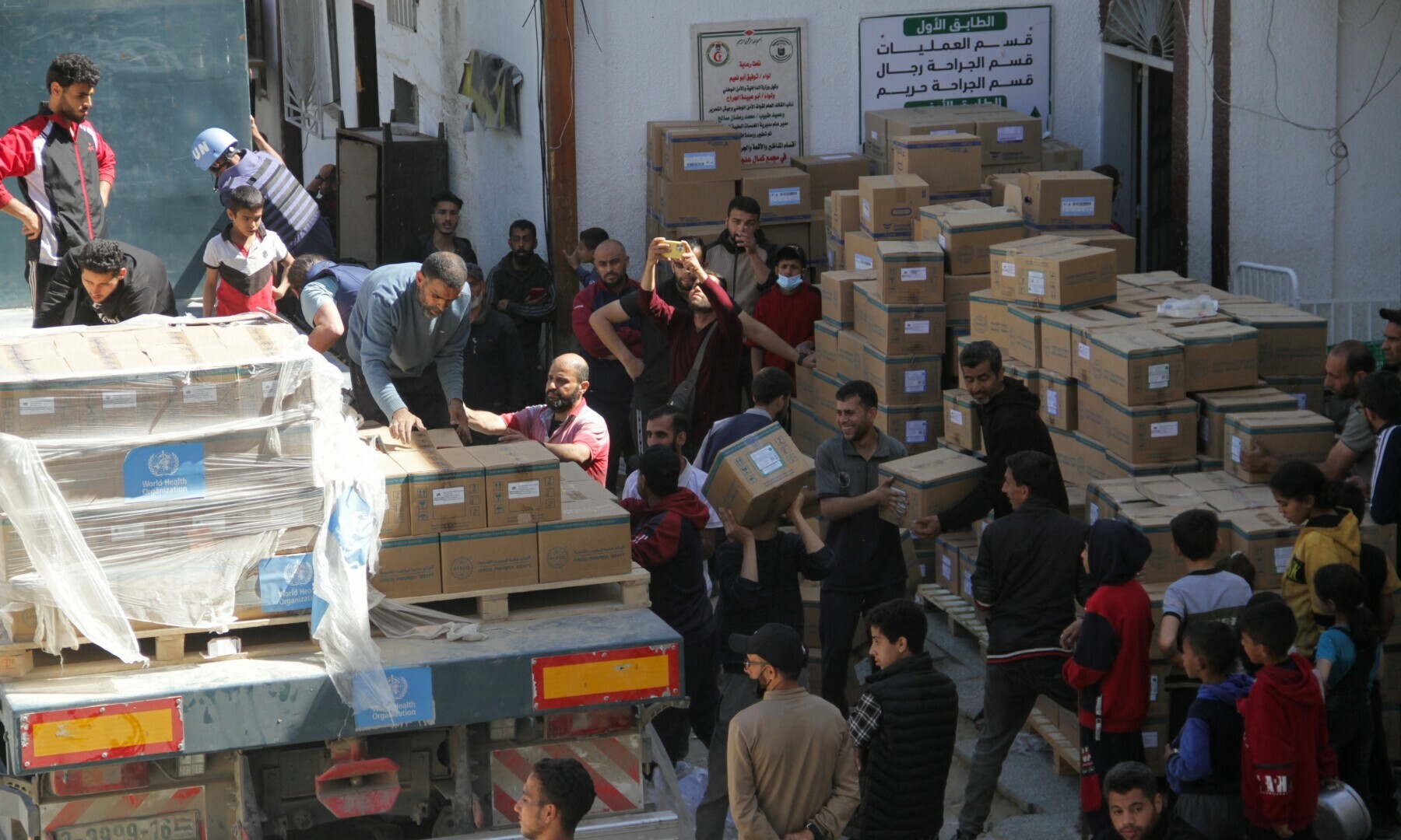  People unload medical aid from a truck, near Kamal Adwan Hospital in the northern Gaza Strip on April 6. &mdash; Reuters 