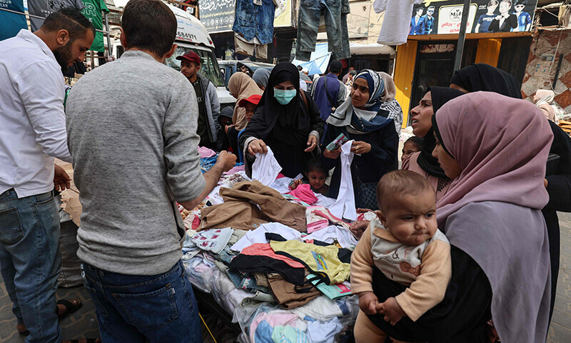 People buy clothing products in a market, ahead of Eidul Fitr, in Rafah in the southern Gaza Strip on April 5, 2024.&mdash;AFP