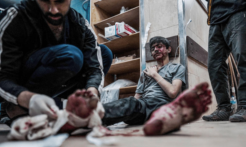  A staff gives first aid to an injured youth at the Al-Aqsa Martyrs Hospital in Deir al-Balah, central Gaza Strip, on April 9. &mdash; AFP 