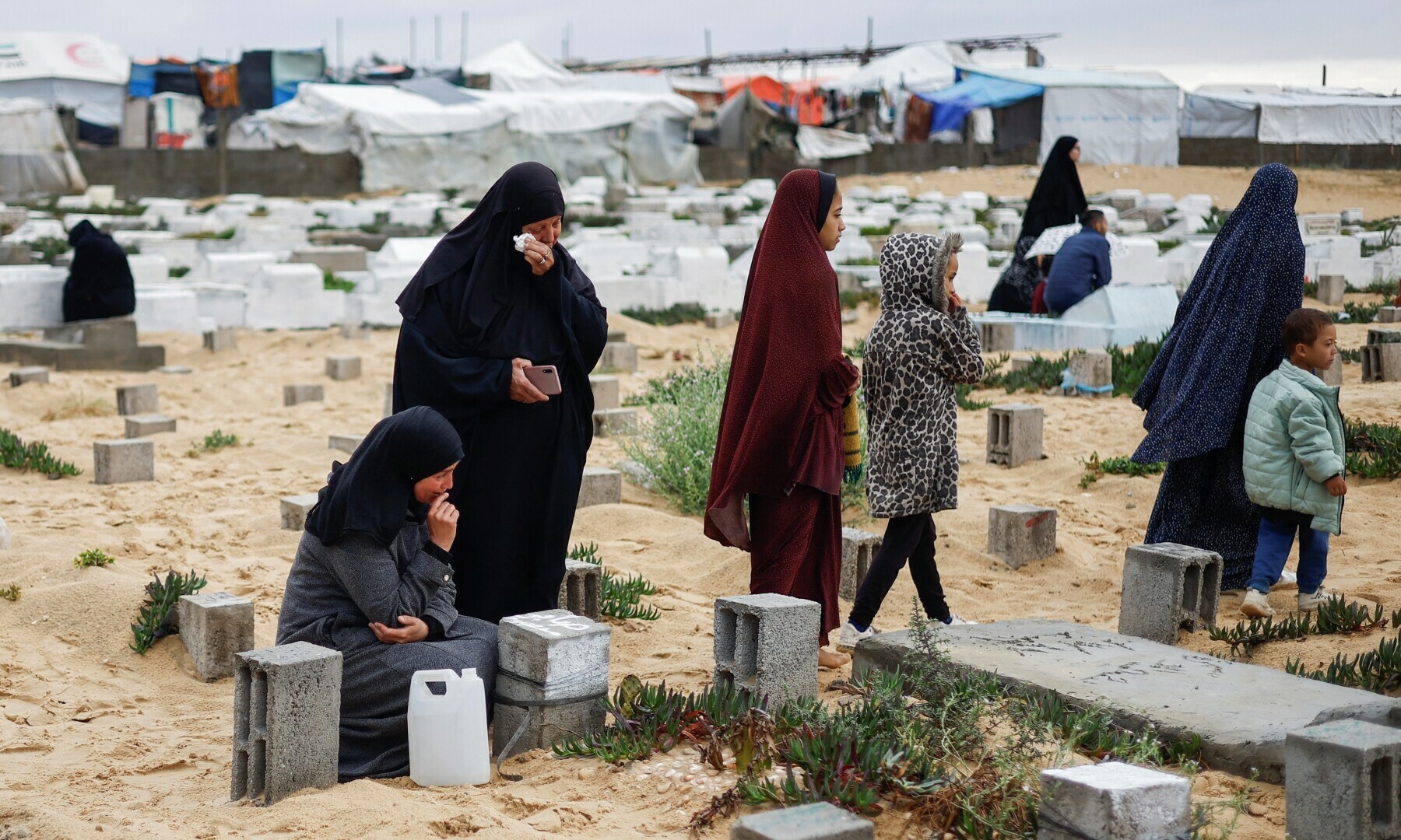  Palestinian women visit the graves of people who were killed in Israel&rsquo;s military operation on Gaza, on Eidul Fitr in Gaza Strip on April 10. &mdash; Reuters 