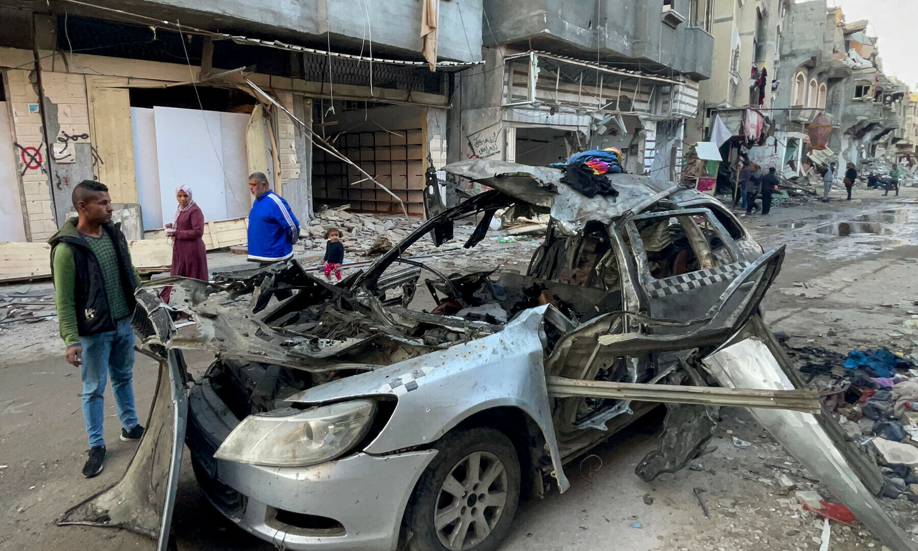  Onlookers check the car in which three sons of Hamas leader Ismail Haniyeh were reportedly killed in an Israeli air strike in al-Shati camp, west of Gaza City on April 10. &mdash; AFP 