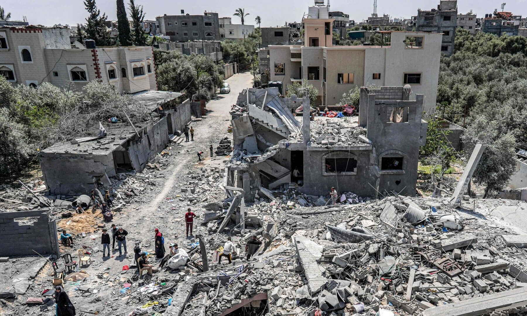  People search through the rubble of a collapsed building in the eastern side of the Maghazi camp for Palestinian refugees in the central Gaza Strip on April 15. &mdash; AFP 