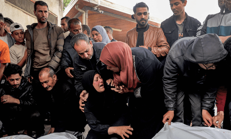  A woman comforts another mourning over the bodies of relatives killed the previous night during Israeli bombardment, at Al-Najjar hospital in Rafah in the southern Gaza Strip on April 16. &mdash; AFP 