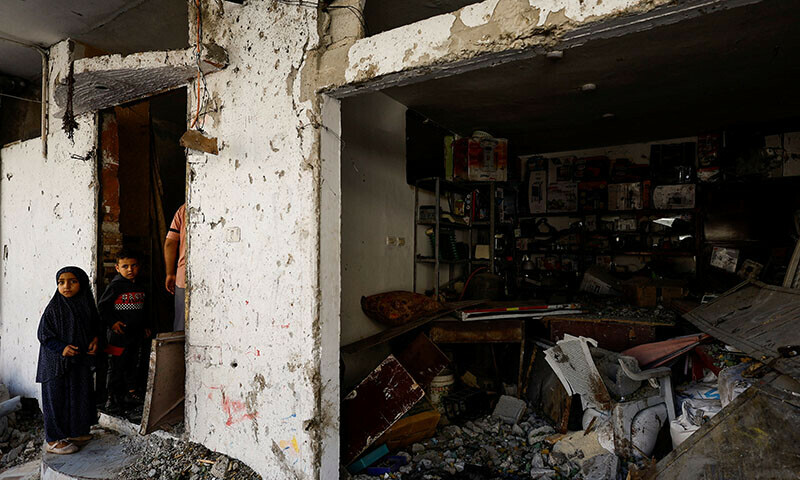 Palestinian children react at the site of an Israeli strike on a house in Rafah, in the southern Gaza Strip on April 17, 2024 &mdash; Reuters
