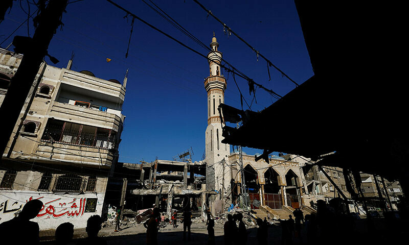 Palestinians stand near the site of an Israeli strike on a house in Rafah, in the southern Gaza Strip on April 17, 2024 &mdash; Reuters