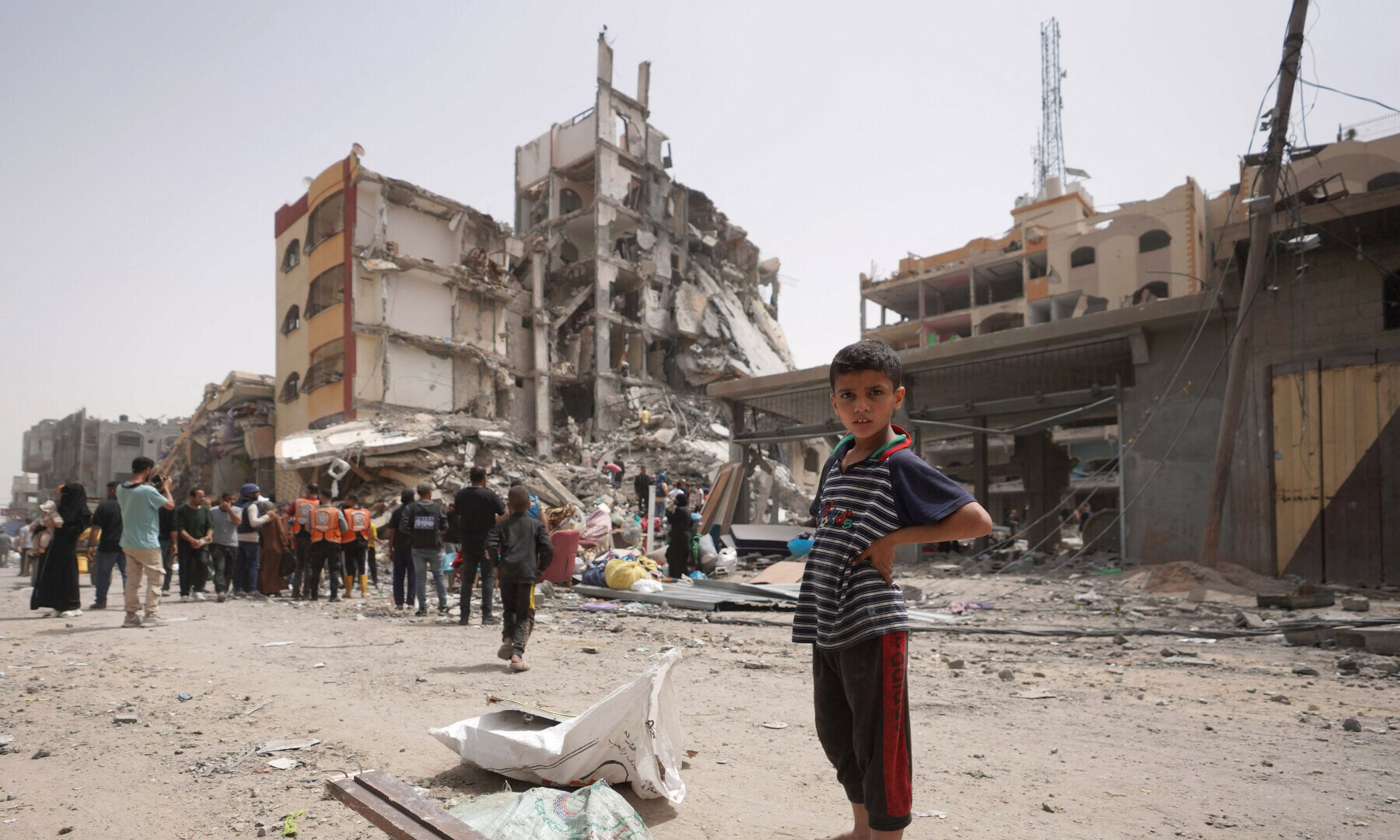  A Palestinian looks at the damage to a building in the city of Nuseirat in the central Gaza Strip on April 18. &mdash; AFP 