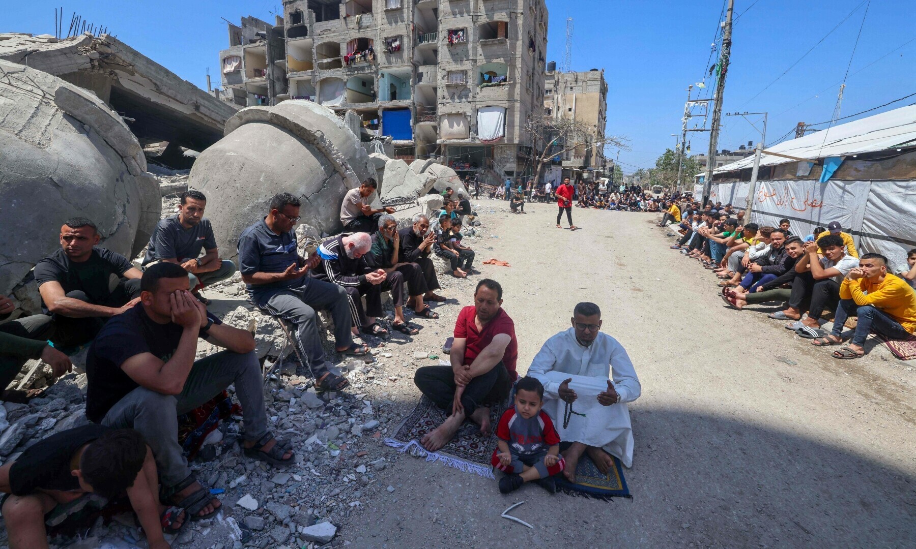  Palestinians perform Friday noon prayer on April 19 next to the ruins of Al-Farooq Mosque, destroyed during Israeli bombardment in Rafah in the southern Gaza Strip. &mdash; AFP 