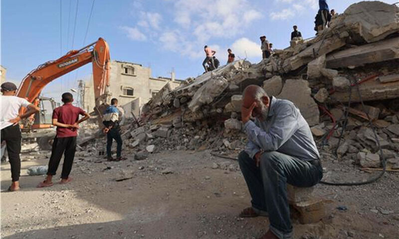 A Palestinian man waits for news of his daughter as rescue workers search for survivors in the rubble of a building hit by overnight Israeli bombing in Rafah, in the southern Gaza Strip on April 21. &mdash; AFP