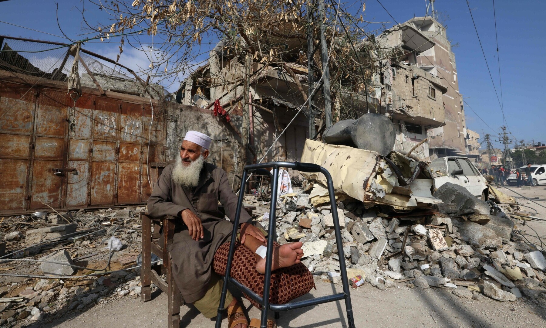  A Palestinian man sits outside a damaged building after Israeli bombardment in Rafah in the southern Gaza Strip, on April 29. &mdash; AFP 