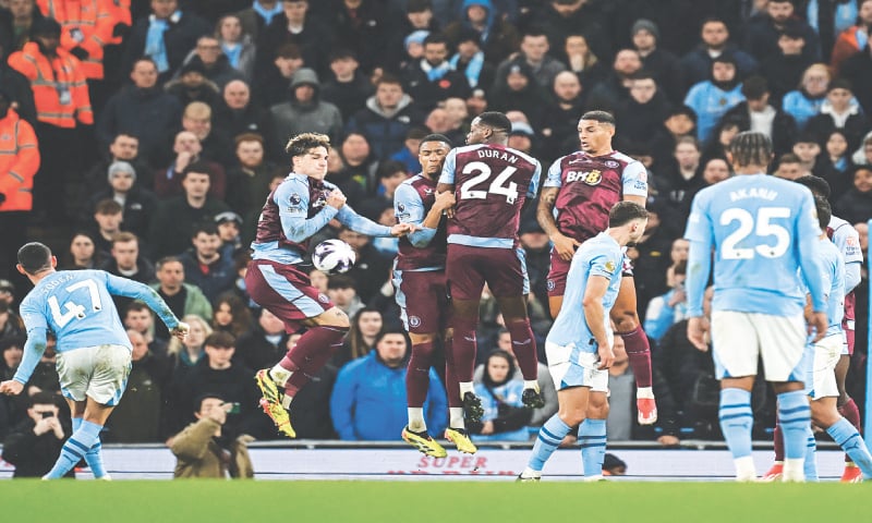 MANCHESTER: Phil Foden (L) of Manchester City shoots to score from the free kick spot against Aston Villa during their Premier League match at the Etihad Stadium.&mdash;AFP