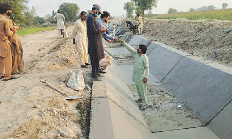 Concrete lining of an irrigation channel under way in Kohat on Thursday. &mdash; Dawn