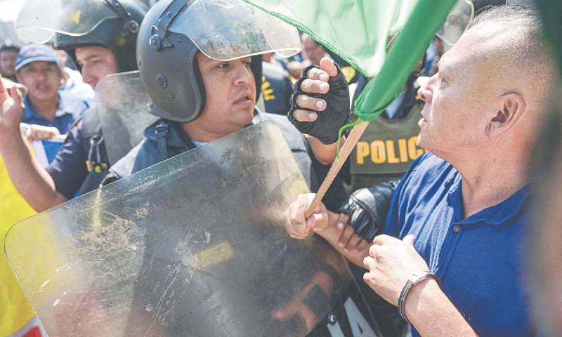 POLICE try to separate supporters and detractors of Peruvian President Dina Boluarte in front of the prosecutor&rsquo;s office in Lima, on Friday.&mdash;AFP