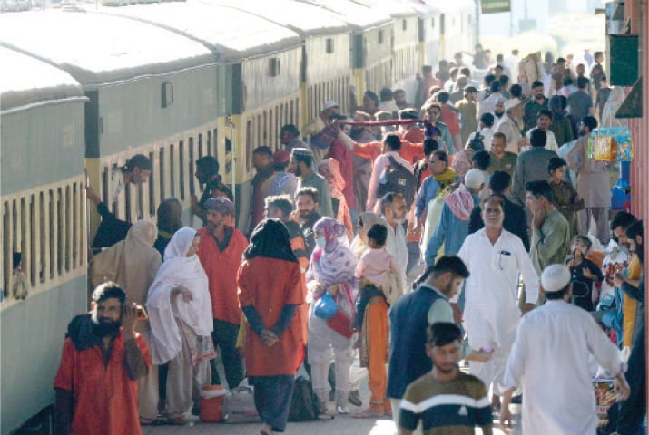 People gather on a platform to board a train for their hometown at Rawalpindi Railway Station on Tuesday. &mdash; White Star