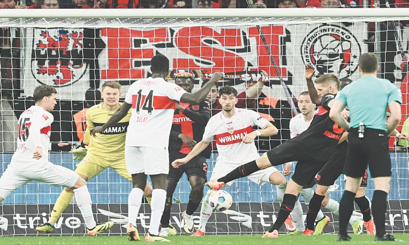 LEVERKUSEN: Robert Andrich (second R) of Bayer Leverkusen shoots to score during the Bundesliga match against Stuttgart at BayArena.—AFP LEVERKUSEN: Robert Andrich (second R) of Bayer Leverkusen shoots to score during the Bundesliga match against Stuttgart at BayArena.—AFP
