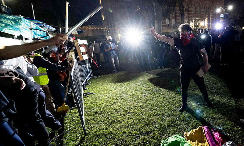 Counter protesters attack a pro-Palestinian encampment set up on the campus of the University of California Los Angeles (UCLA) on May 1. &mdash; AFP)