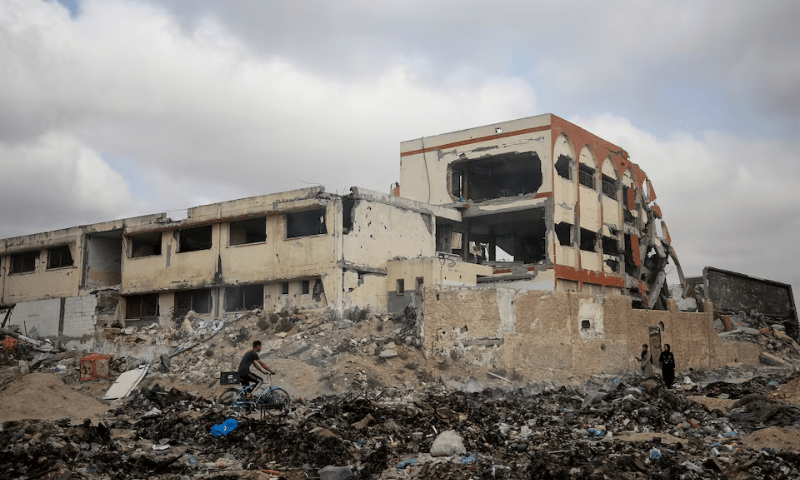 Palestinians pass by a school destroyed during Israel&rsquo;s military offensive, amid the ongoing conflict between Israel and Hamas, in Gaza City April 28, 2024. &mdash; Reuters