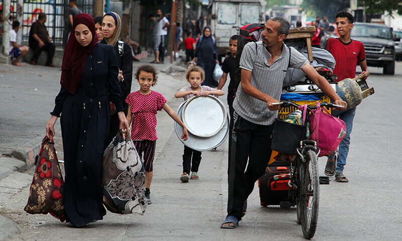 Palestinians travel on foot along with their belongings as they flee Rafah due to an Israeli military operation on May 28. &mdash; Reuters