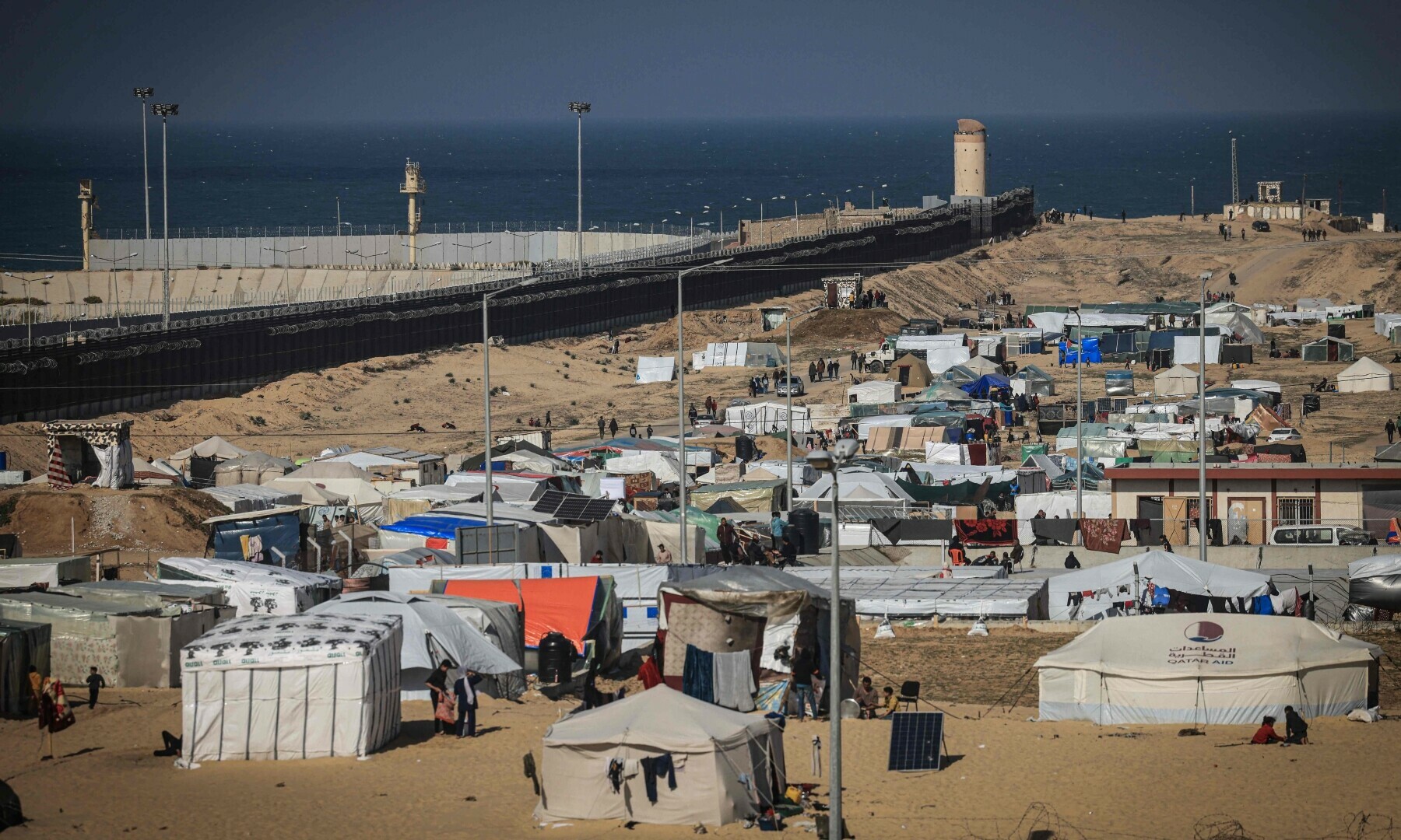  Displaced Palestinians gather at a makeshift camp along the Philadelphi, or Salaheddin corridor, in the southern Gaza Strip on Jan 14, 2024. &mdash; AFP/File 