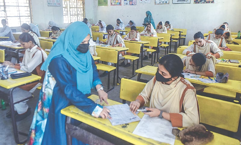A student signs the attendance sheet during the paper.—Fahim Siddiqi / White Star A student signs the attendance sheet during the paper.—Fahim Siddiqi / White Star