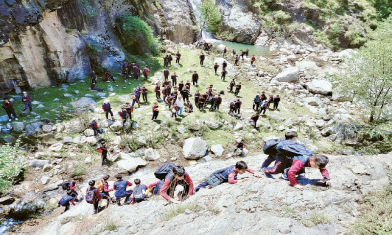 Students climb a mountain during the hike. &mdash; Dawn