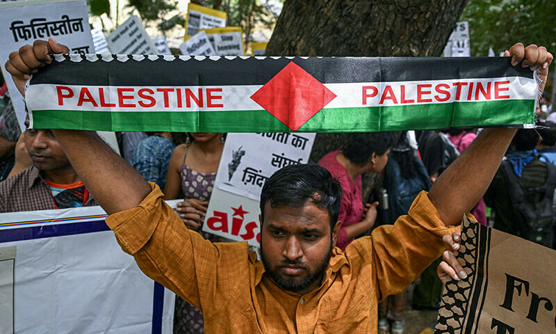 An activist holds a Palestinian flag during a demonstration in New Delhi to express solidarity with Palestinians on June 1. &mdash; AFP