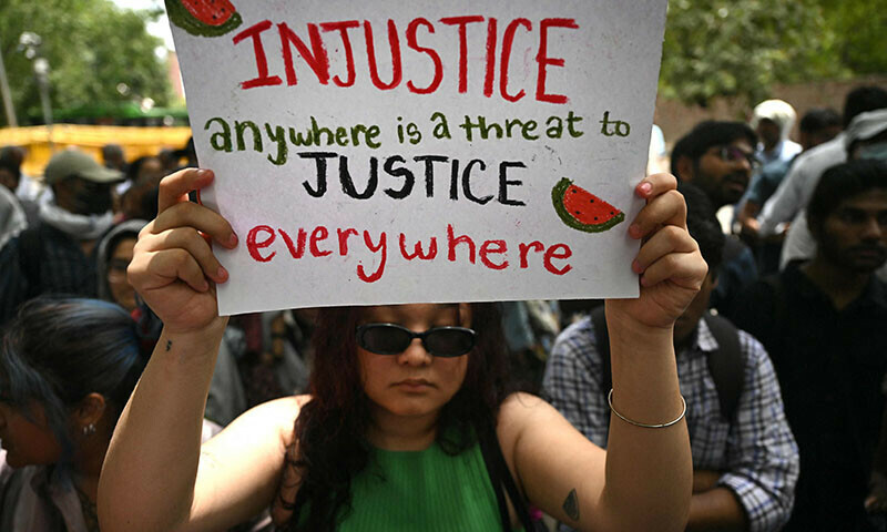 An activist holds a placard during a demonstration to express solidarity with  Palestinians in New Delhi on June 1. &mdash; AFP