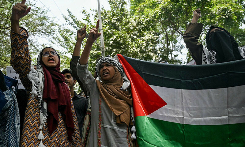 Activists holding a Palestinian flag shout slogans during a demonstration in New Delhi to express solidarity with Palestinians on June 1. &mdash; AFP