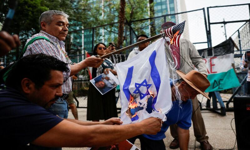 Demonstrators set fire to the flags of Israel and the US during a protest outside the US Embassy in support of Palestinians in Gaza and to condemn the Israeli airstrikes in the southern Gaza Strip city of Rafah in Mexico on June 1, 2024. &mdash; Reuters