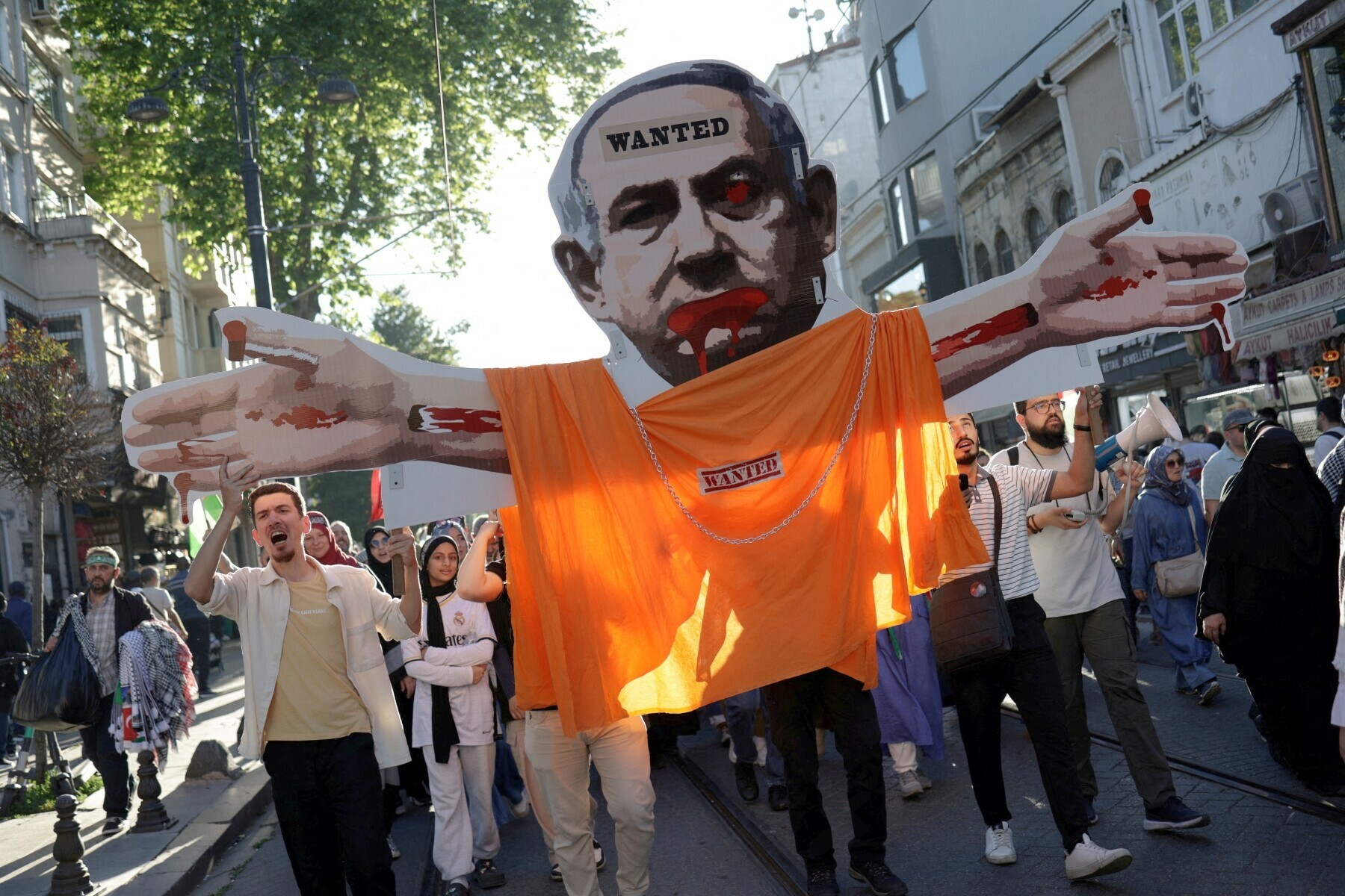  Demonstrators carry a placard depicting Israeli Prime Minister Benjamin Netanyahu during a pro-Palestinian rally, in Istanbul, Turkiye on June 1, 2024. &mdash; Reuters 