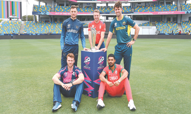 BRIDGETOWN (Barbados): (L to R) Scotland captain Richie Berrington, Namibia skipper Gerhard Erasmus, England captain Jos Buttler, Oman skipper Aqib Ilyas and Australian captain Mitchell Marsh pose with the trophy at the Kensington Oval on Saturday.&mdash;AFP