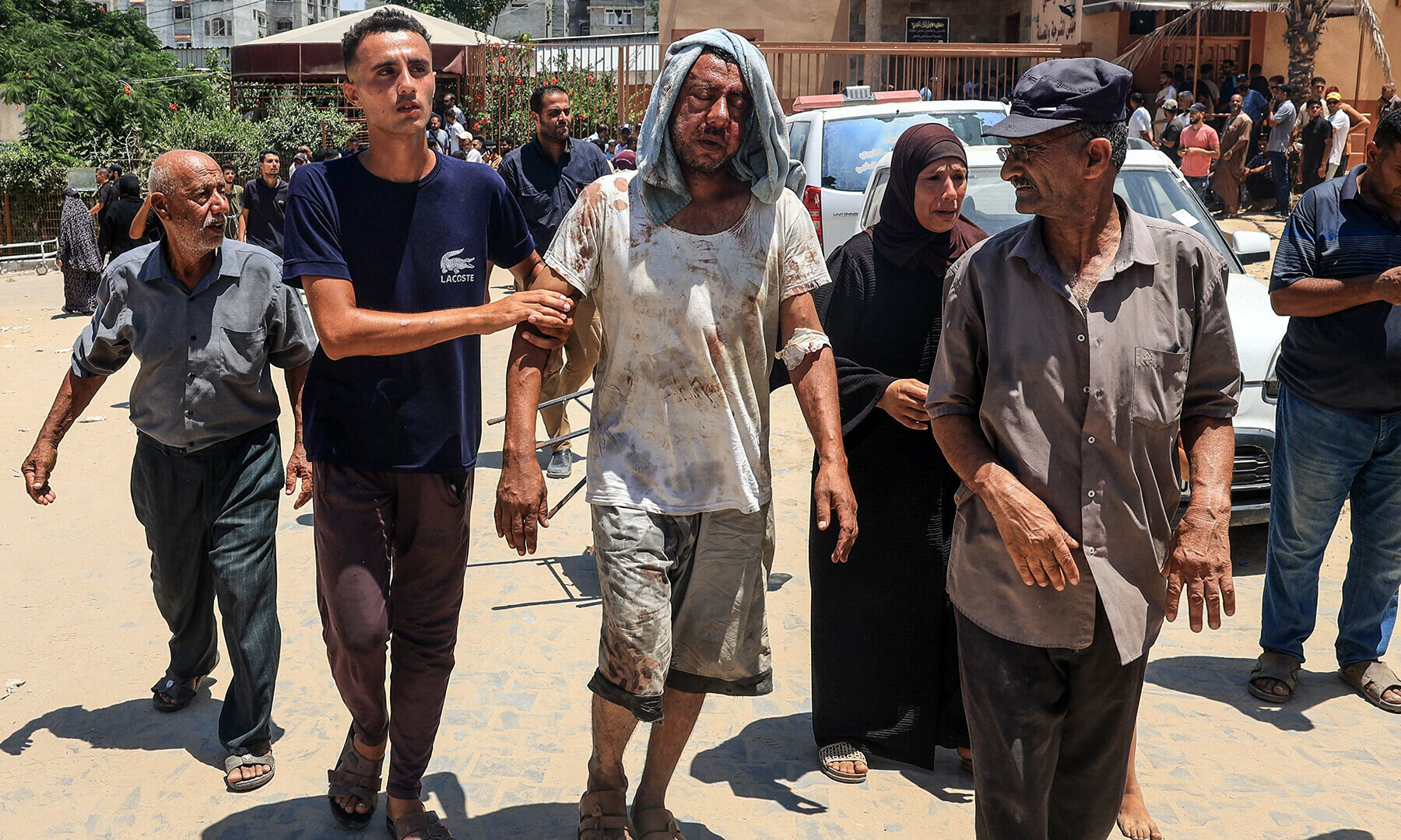 An injured Palestinian man is escorted to the Nasser hospital in Khan Younis on July 13, 2024.&mdash;AFP