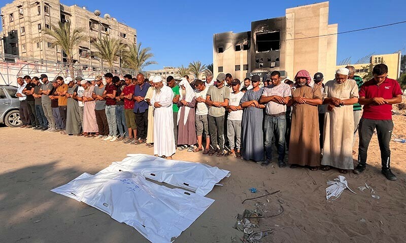 Mourners pray next to the bodies of Palestinians killed in Israeli strikes, amid the Israel-Hamas conflict, at Nasser hospital in Khan Younis in the southern Gaza Strip on July 30, 2024 &mdash; Reuters