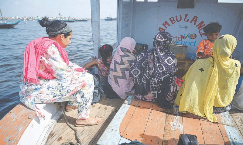 Midwife Neha Mankani (left) travels to Baba Island on a boat ambulance.—AFP Midwife Neha Mankani (left) travels to Baba Island on a boat ambulance.—AFP