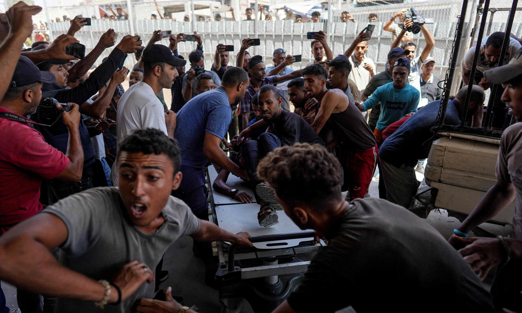  People use their mobile phones to take images as victims of Israeli bombardment are rushed into Nasser hospital in Khan Yunis, in the southern Gaza Strip on Aug 7, 2024. &mdash; AFP 