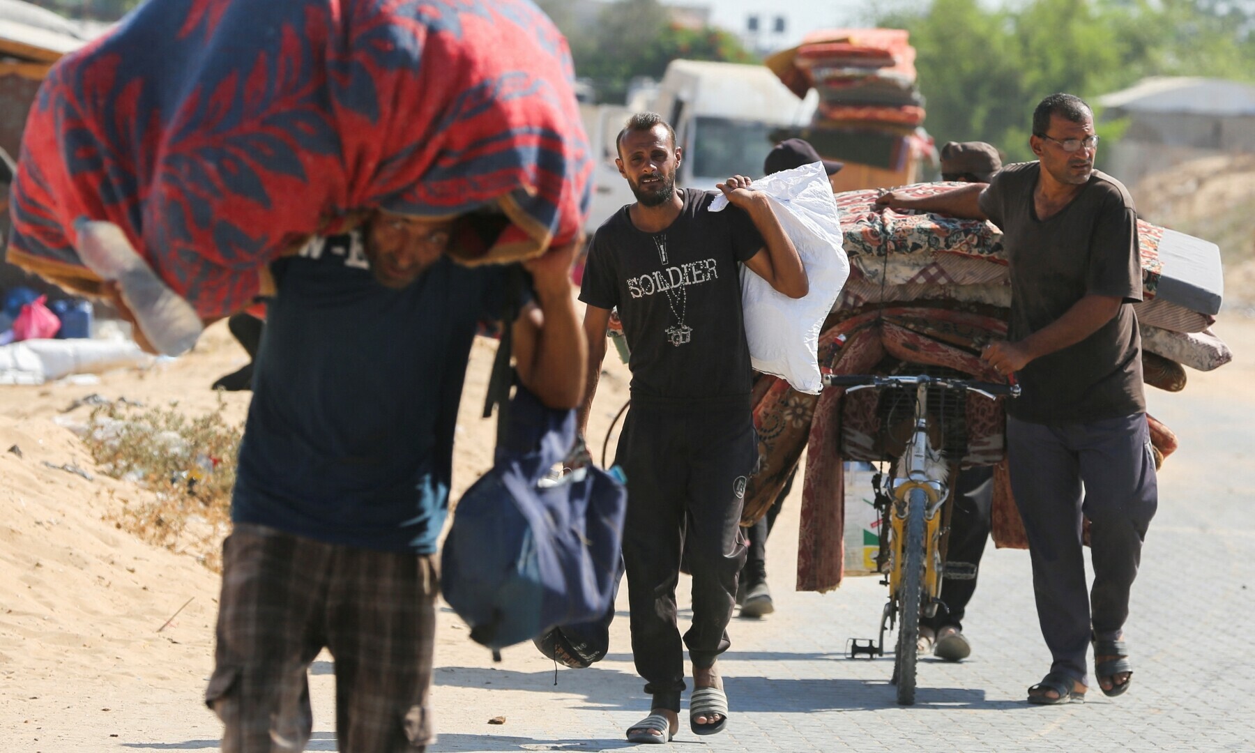  Displaced Palestinians make their way as they flee Hamad City following an Israeli evacuation order, in Khan Younis in the southern Gaza Strip on Aug 11, 2024. &mdash; Reuters 