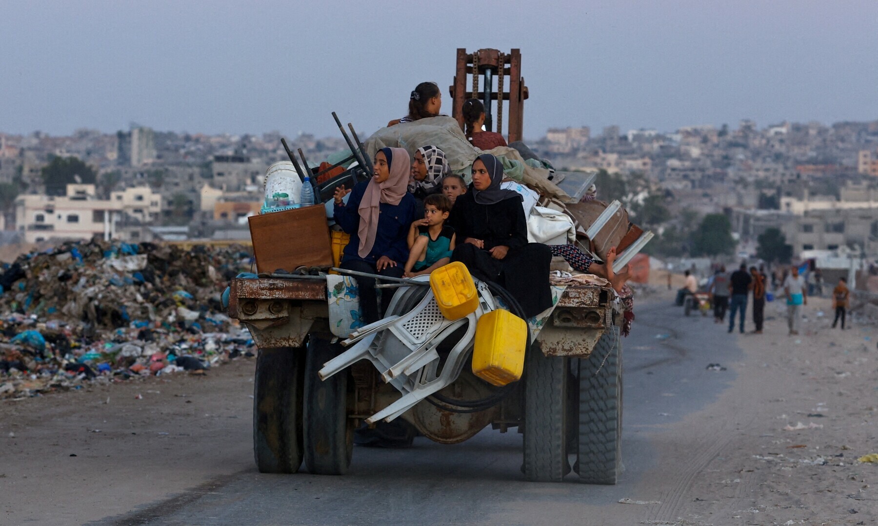  Displaced Palestinians travel on a cart after fleeing the western part of Khan Younis, following an evacuation order by the Israeli army, in the central part of Khan Younis in southern Gaza strip on Aug 21, 2024. &mdash; Reuters 