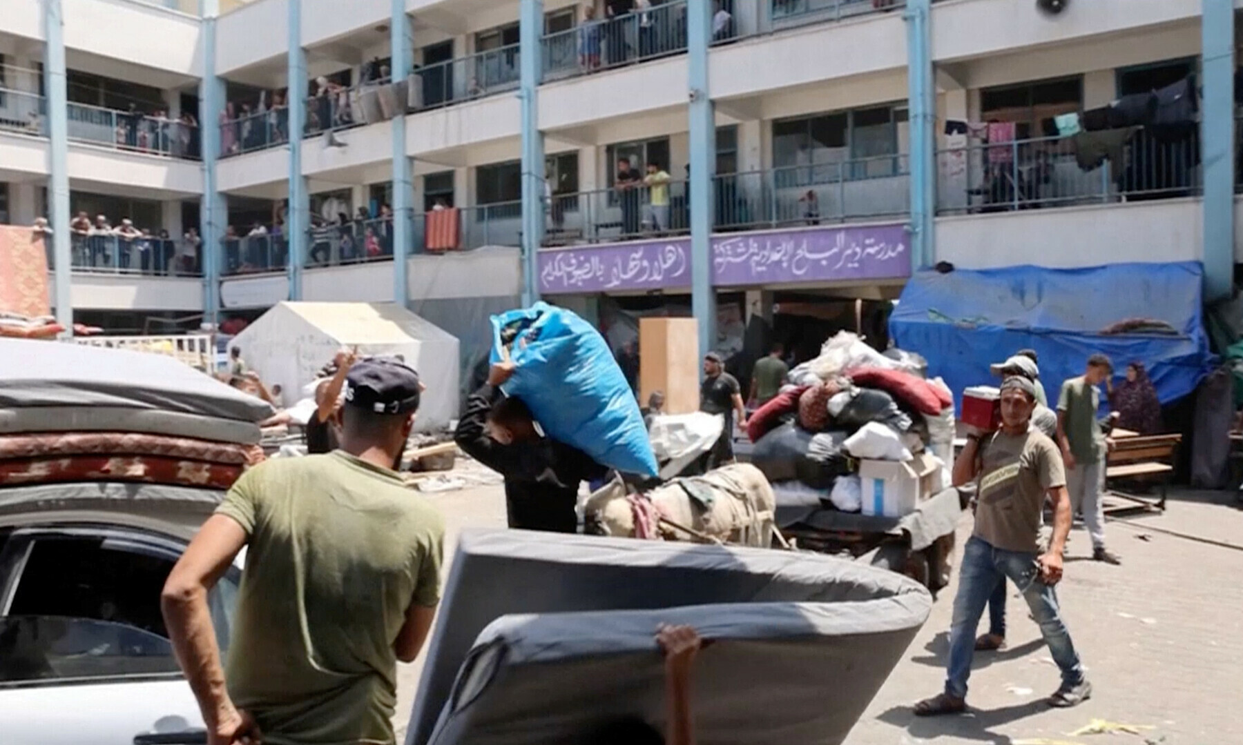  Palestinians load their carts and vehicles with belongings as they evacuate Deir al-Balah Boys&rsquo; Preparatory School following an evacuation order by the Israeli army, in the east of Deir al-Balah of the central Gaza Strip on Aug 16, 2024. &mdash; OCHA via Reuters 