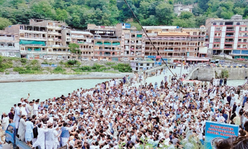 A large number of residents block the main Madyan-Kalam Road in protest in Swat on Friday against the long delay in construction of Chail Bashigram Road. &mdash; Dawn