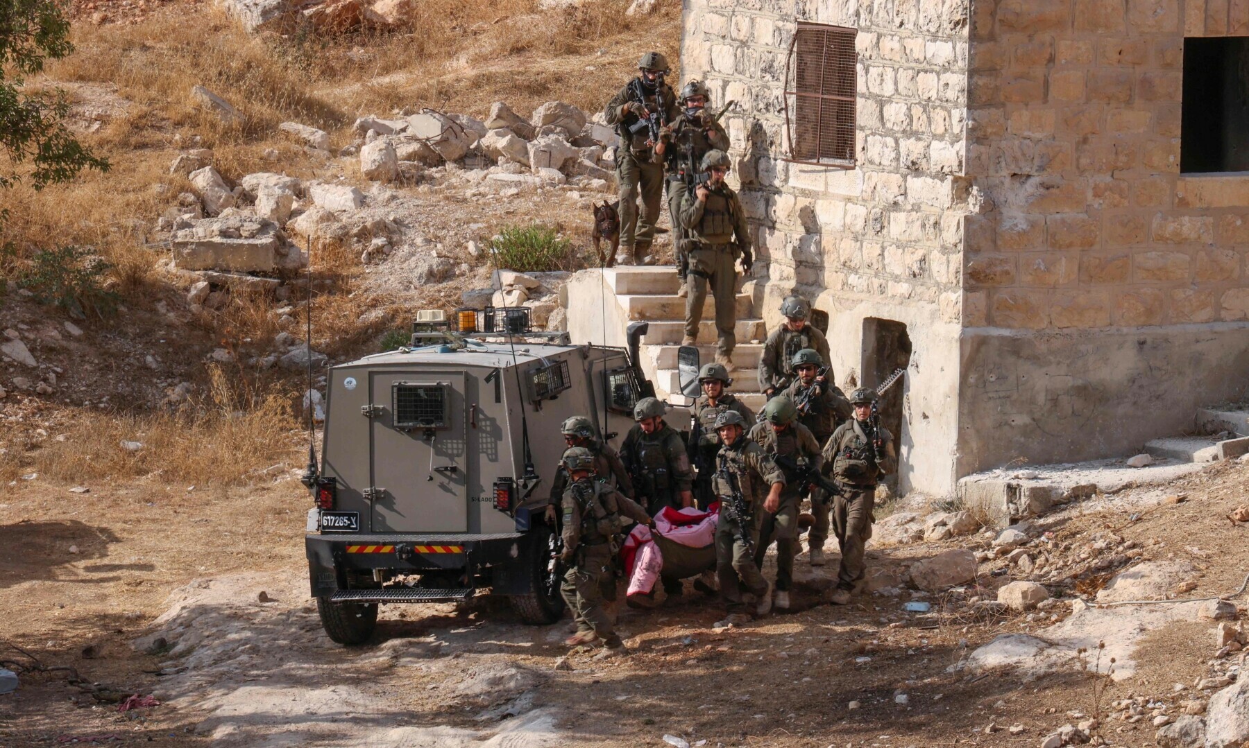  Israeli security forces transport the body of a Palestinian man from an old building during a raid in Hebron city in the occupied West Bank on Sept 1, 2024. &mdash; AFP 