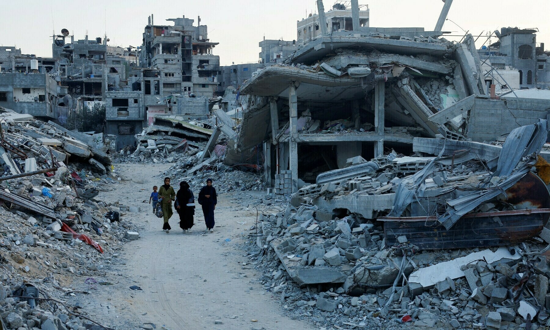  Palestinian walk amidst the rubble of buildings destroyed after an Israeli strike, in Khan Younis, in the southern Gaza Strip on Sept 1, 2024. &mdash; Reuters 