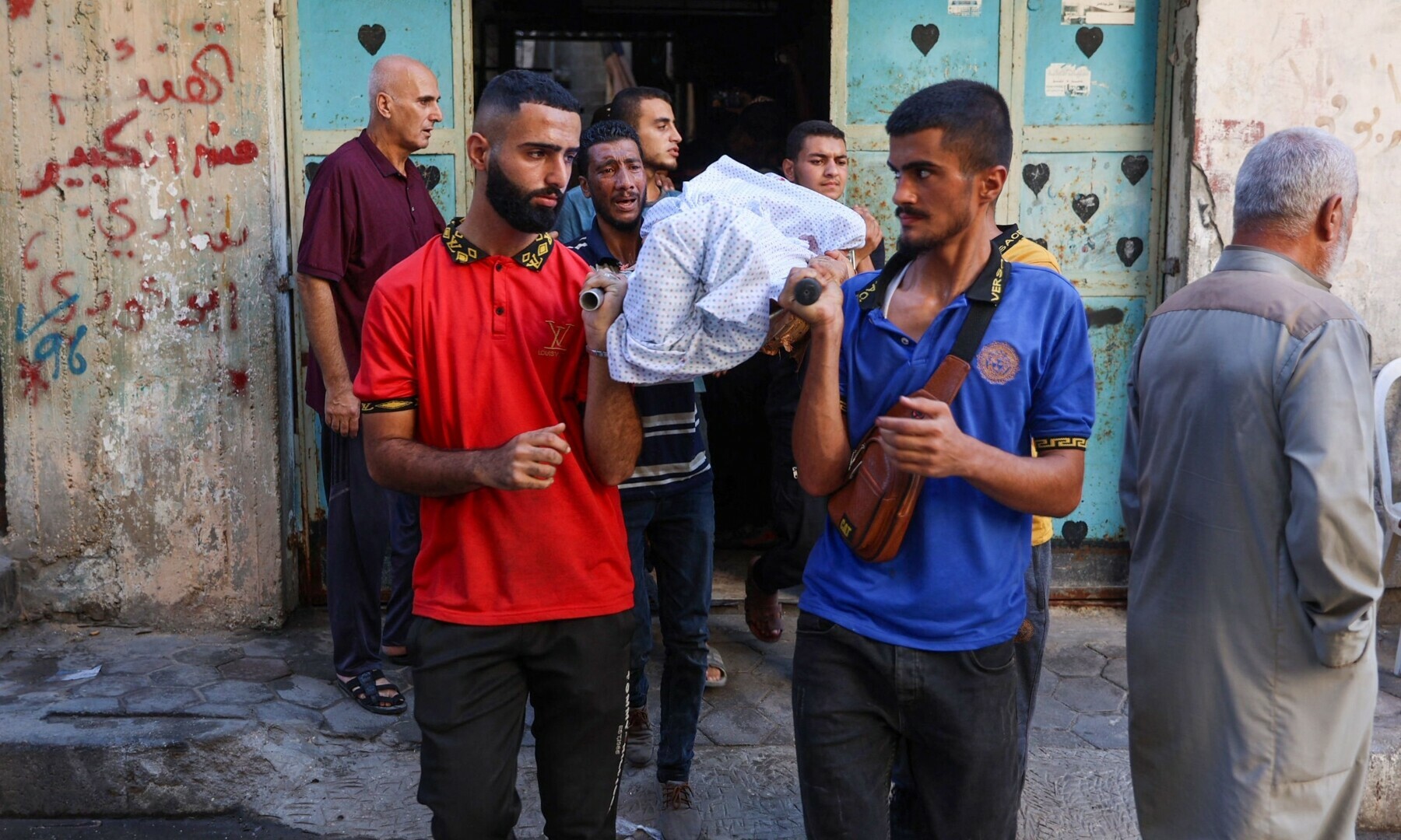  People carry the shrouded body of a man killed during an Israeli strike on the Amr Ibn al Aas school housing displaced Palestinians in the Sheikh Radwan neighbourhood in Gaza City on Sept 7, 2024. &mdash; AFP