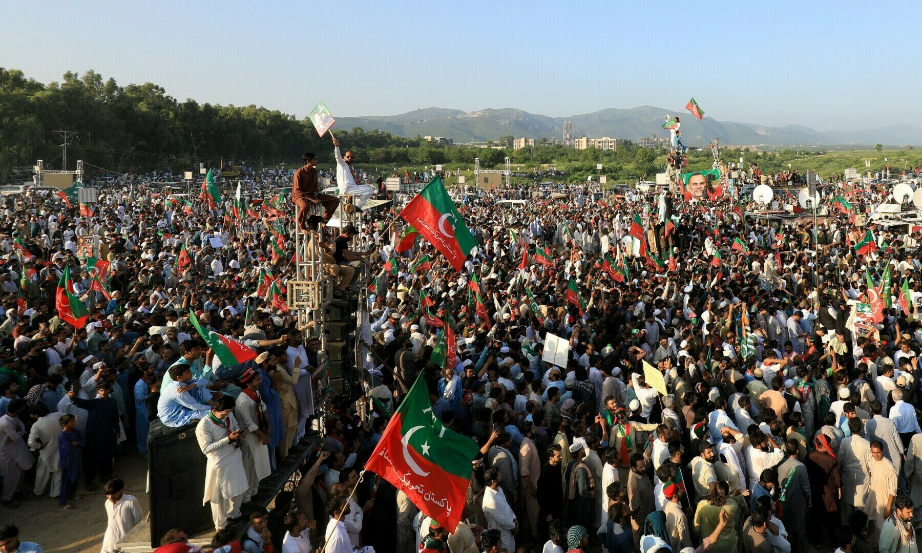 PTI supporters wave party flags during a rally in Islamabad on Sept 8, 2024. &mdash; Reuters
