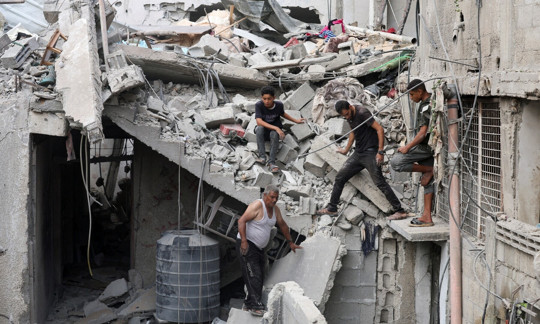  Palestinians inspect the site of an Israeli strike on a house, in Nuseirat in the central Gaza Strip, on Sept 16, 2024. &mdash; Reuters 