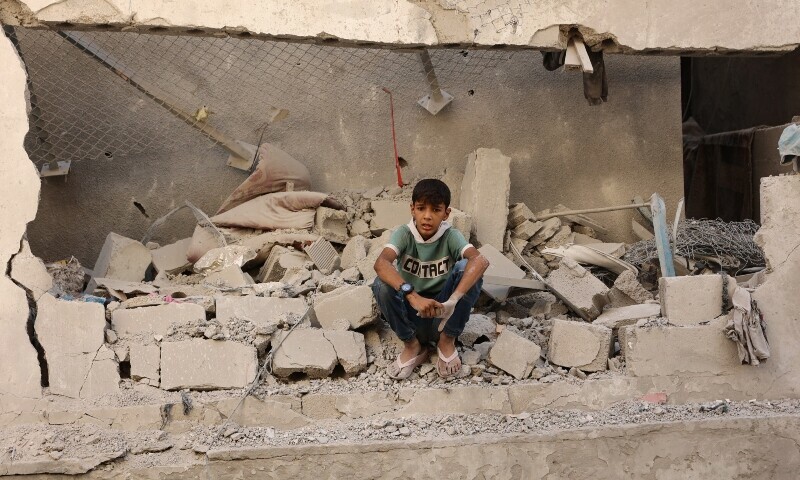 A Palestinian boy sits amongst the debris at the site of an Israeli strike on a school housing displaced Palestinians in Gaza City&rsquo;s Zaytoun neighbourhood on September 21. &mdash; AFP