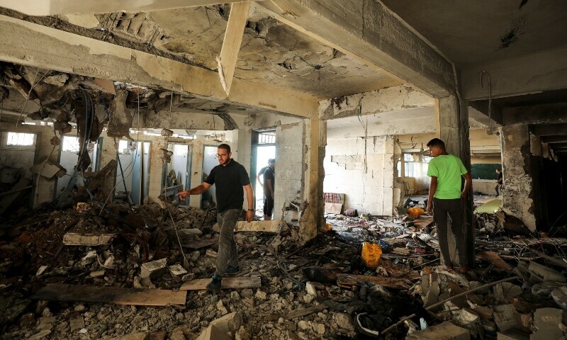 Palestinians inspect a school, which was sheltering displaced people, after it was hit by an Israeli strike, amid the Israel-Hamas conflict, in Gaza City, September 21. &mdash; Reuters