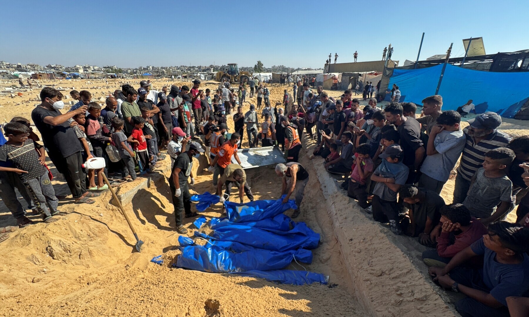 People bury in a mass grave unidentified bodies of Palestinians killed in Israel&rsquo;s military offensive, after they were handed over by Israel, in Khan Younis in the southern Gaza Strip on Sept 26, 2024. &mdash; Reuters 