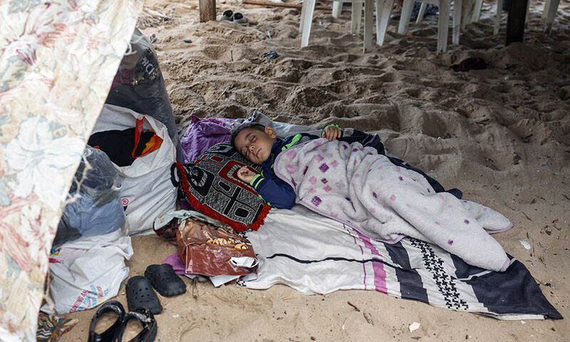 A displaced child sleeps at a makeshift encampment where scores of displaced people live, amid cross-border hostilities between Hezbollah and Israeli forces, at a beach in Beirut, Lebanon on October 1. &mdash; Reuters